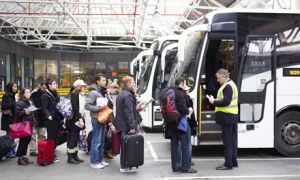 Passengers board a National Express bus at Victoria coach station